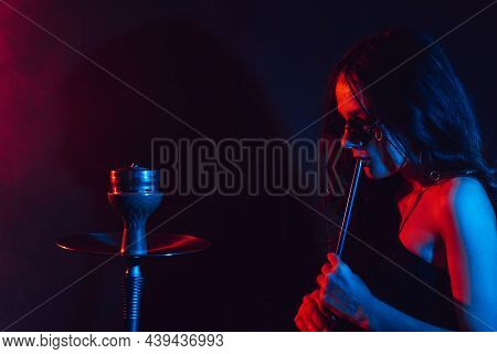 Hookah Atmosphere. The Girl Enjoys Smoking A Hookah, Sheesha. Place For Your Text