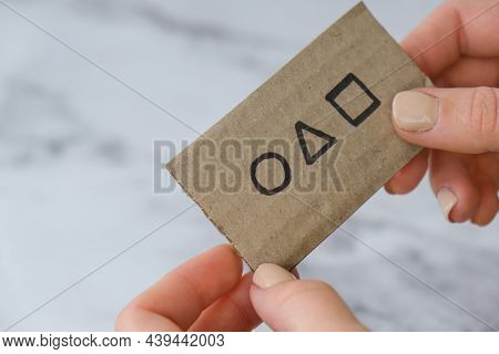 Kiev Ukraine - October 2021 Hand Holding A Squid Game Invitation Card. Symbol Of Squid Game Cardvisi