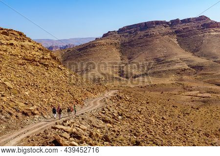 Petra, Jordan - October 24, 2021: View Of Desert Mountain Landscape, With Locals And A Donkey, Near 