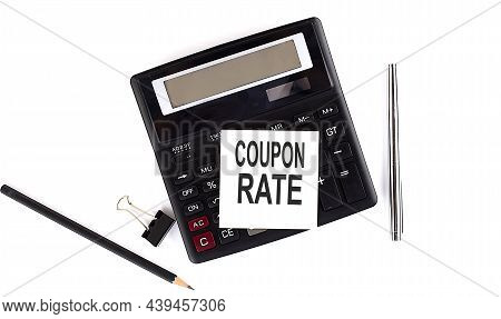 Coupon Rate Text On Sticker On Calculator With Pen,pencil On The White Background