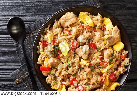 Peruvian Fried Rice With Chicken, Omelet, Peppers And Onions Close-up In A Bowl On A Wooden Table. H