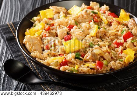 Peruvian Fried Rice With Chicken, Omelet, Peppers And Onions Close-up In A Bowl On A Wooden Table. H