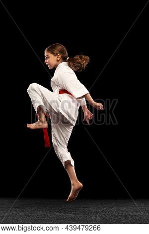 Karate, Taekwondo Girl With Yellow Belt Isolated On Dark Background In Neon Light. Concept Of Sport,