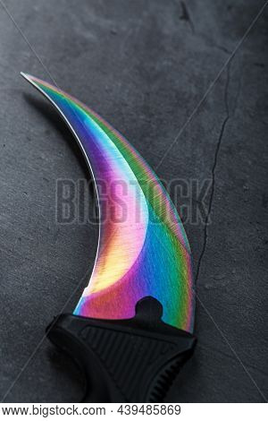 A Dagger With A Steel Blade With A Gradient Color On A Black Background.