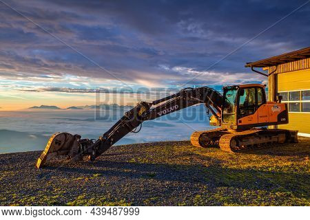Carnic Alps, Austria - August 20, 2016: Yellow Excavator In The Ski Resort. Autumn Morning In Ski Re