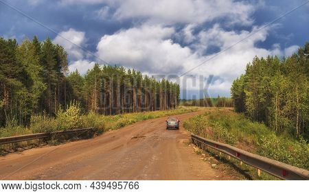 July 27, 2021 Dirt Road To Zaonezhie, Republic Of Karelia Russia.  Suv On A Red Clay Road In The Mid
