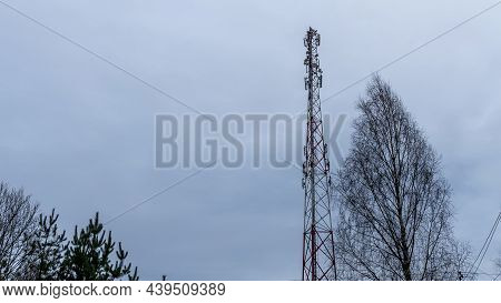 Tower With Mobile Operator Antennas On The Dramatic Sky Background. Tower Hosted Equipment Cellula. 