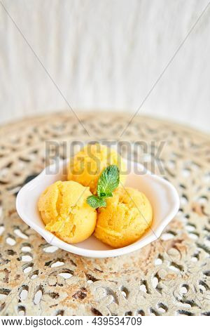 Mango Ice Cream With Mint Leaf. Three Balls In A White Bowl On A Vintage Table. Sorbet