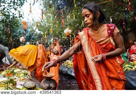 Delhi, India: 13 November 2021 - Close Up Of Indian Woman Lighting Up Diya In Chhath Pooja, Woman Ce