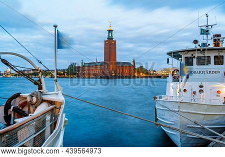 Stockholm, Sweden - Okt 22, 2005: Local ferry transportation in Stockholm in foreground and the city hall