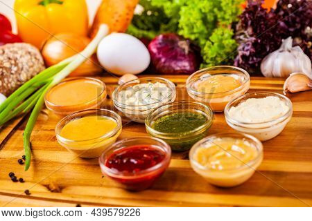 Different Sauces Assortment On Wooden Cutting Board