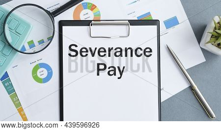 Paper With Severance Pay On A Table. Business Concept