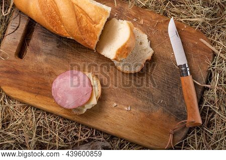 French Folding Knife And Sausage Sandwich. A Folding Kitchen Knife And A Homemade Sandwich.