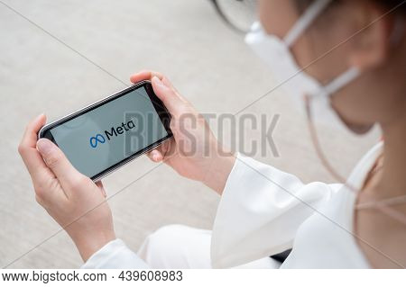 Chiang Rai Province, Thailand : 30-10-2021 : Woman Holding Her Smart Phone And Looking To Meta Symbo
