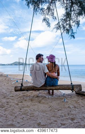 Bang Tao Beach Phuket Thailand, Beach With Palm Trees And A Couple Man And Women In The Swing On The