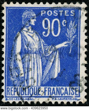 Vintage Stamp Printed In France Circa 1938 Shows Antique Character With Olive Branch