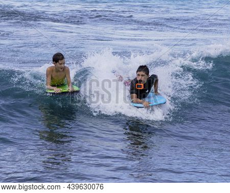 Honolulu, Hawaii - Nov 6, 2021-young Boys Play On Their Boogey Boards In The Surf.