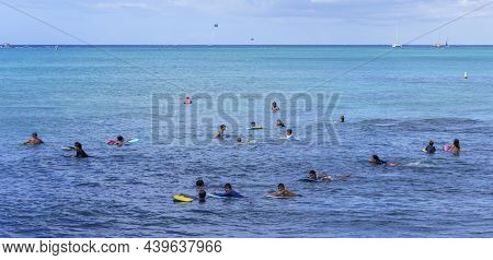 Honolulu, Hawaii - Nov 6, 2021-young People Wait With Their Boogey Boards For The Next Surf Wave.