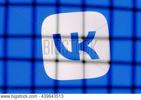 Kazan, Russia - Nov 13, 2021: The Logo Of The Social Network Vkontakte Behind Bars. The Concept Of V