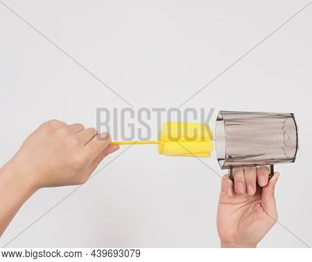 Clean And Wash Dish Concept. Man Hand Washing Drink Glass On White Background.