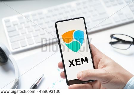 Russia Moscow 08.06.2021.logo Of Xem Coin In Mobile Phone.cryptocurrency Token.trading Ecosystem Blo