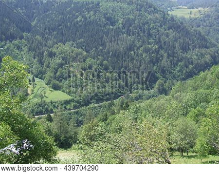 Passenger Train Riding Among Mountains. Mountain Landscape. Railway Transport In Mountains. Landscap