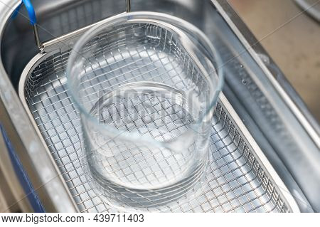 Chemical Beaker In Ultrasound Bath For Cleaning And Degassing Liquid Or Dissolving Of Substances.