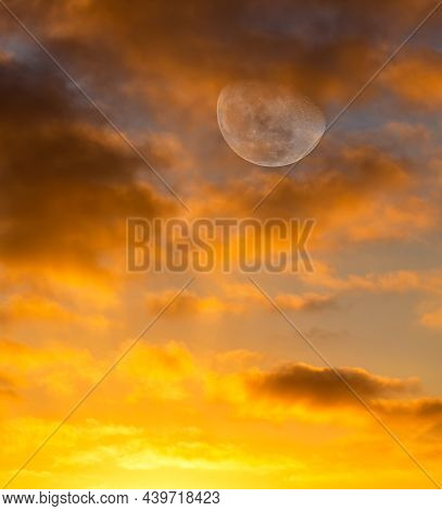 The Full Moon Is Rising In The Colorful Golden )range Sunset Sky In Vertical Image Format