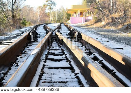 Empty Railway Track And Railway Platform On A Sunny Winter Day. Selective Focus.