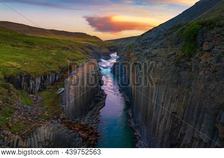 Studlagil Canyon With The Jokulsa A Bru River In East Iceland Photographed At Sunset.