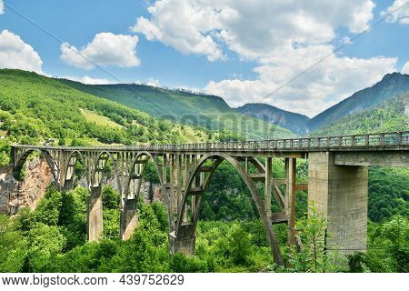 Bridge Durdevica Over The Green Fjord In Montenegro. Panoramic Nature Backgrounds And Landscapes