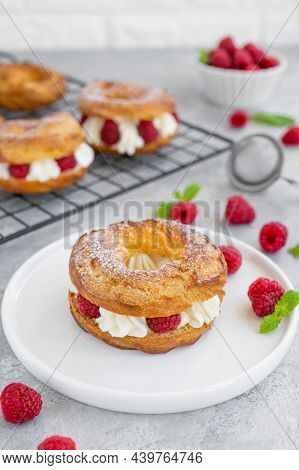 Choux Pastries. Choux Rings With Cream Of Cream Cheese Or Cottage Cheese And Fresh Raspberries, Dust