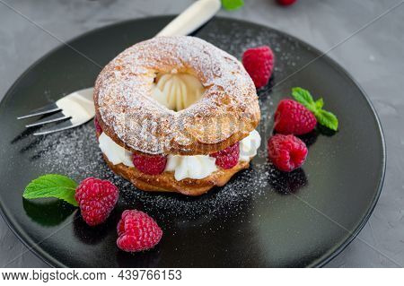 Choux Pastries. Choux Rings With Cream Of Cream Cheese Or Cottage Cheese And Fresh Raspberries, Dust