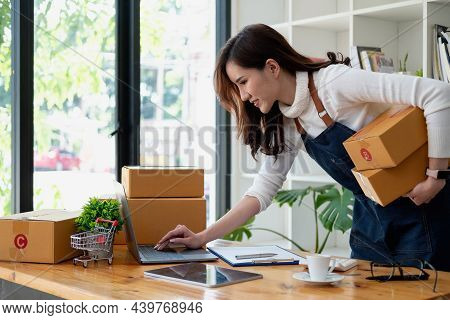 Start Up Small Business Entrepreneur Sme Or Freelance Asian Woman Using Laptop With Box, Young Succe