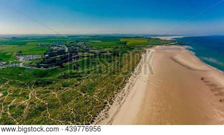 UK, England, Northumberland, Bamburgh Castle on hill near beach