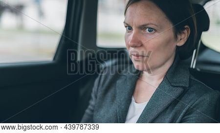 Worried Businesswoman Sitting At Car Back Seat, Looking Nervous And Anxious