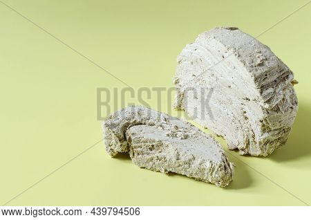 Peanut Halva On A Yellow Background Is A Place For Text. Halva From Oriental Sweets.