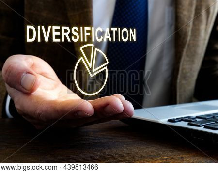 Businessman Holds Sign Diversification As Part Of Risk Management.