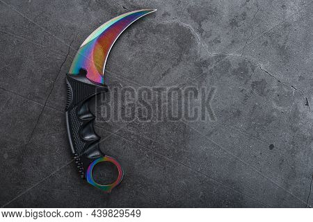 A Dagger With A Steel Blade With A Gradient Color On A Black Background.