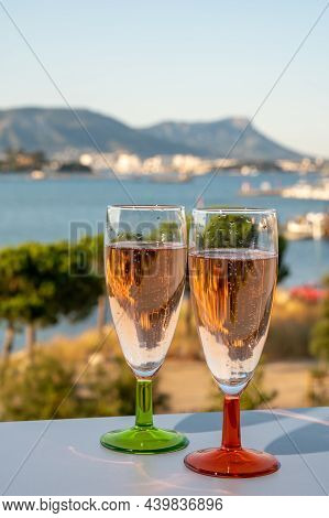 Summer Party, Drinking Of French Champagne Rose Sparkling Wine In Glasses With View On Fishermen Har