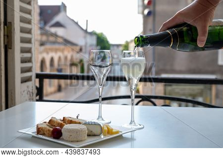 Romantic Party With Two Glasses Of White Cold Champagne And View On Old Street In French Village