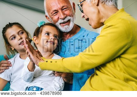 Happy Children Having Fun And Love With Their Grandparents Together. Family Poeple Fun Concept