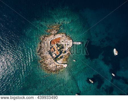 Boats Stand Near The Island Of Otocic Gospa. Montenegro. Drone