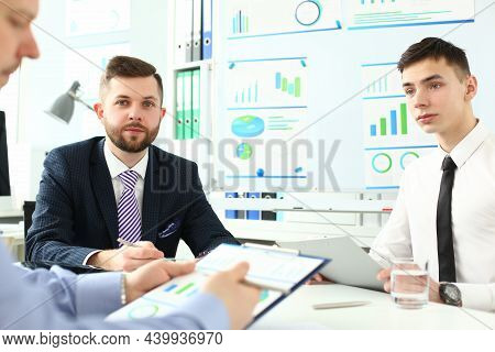 Portrait Of Young Manager Talking About With Interested Boss. Smart Colleagues Discussing Questionab
