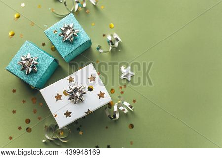 Gift White And Green Boxes With A Tinsel And Confetti On A Green Background. The Concept Of A Gift, 