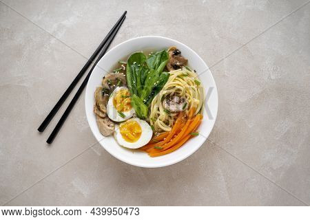 Assian Vegan Soup With Noodles, Vegetable Broth, Mushrooms, Eggs, Carrots And Choi Sum Leaves