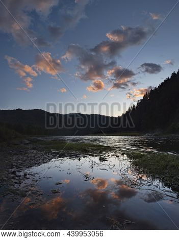 Russia. Chita Region. A Picturesque Sunset Sky With Flaming Clouds Over The Mountains Of The Menza R
