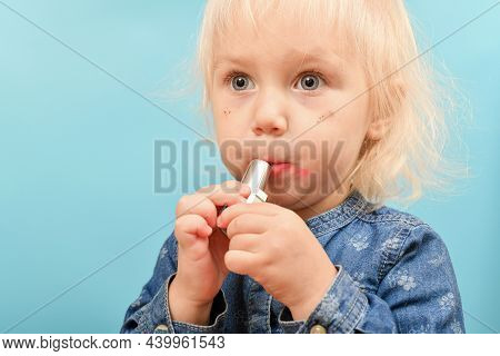 The Child Secretly And Ineptly Paints His Lips With Maya Red Lipstick.