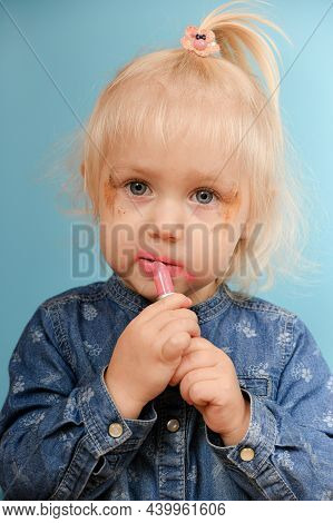 The Child Secretly And Ineptly Paints His Lips With Maya Red Lipstick.