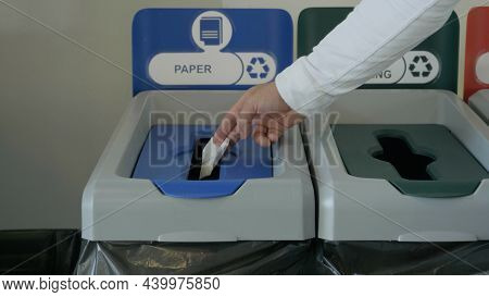 Throwing A Piece Of Paper In A Special Bin For Waste Recycling, Concept Of Ecology. Hdr. Close Up Of